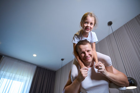 Girl and her dad are having fun morning get upの写真素材