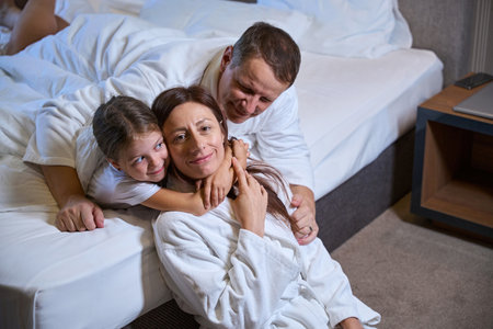 Happy family relaxing in a hotel roomの写真素材