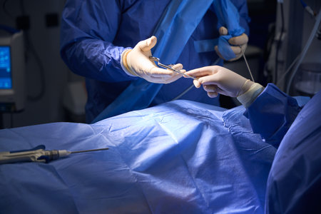 Close-up of surgeons hands exchanging surgical instruments