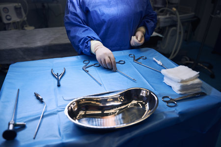 Close-up of hands arranging surgical tools