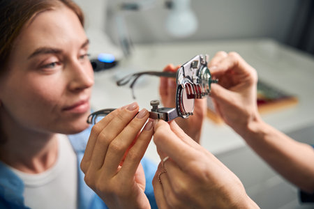 Female patient examining lenses in trial frameの写真素材
