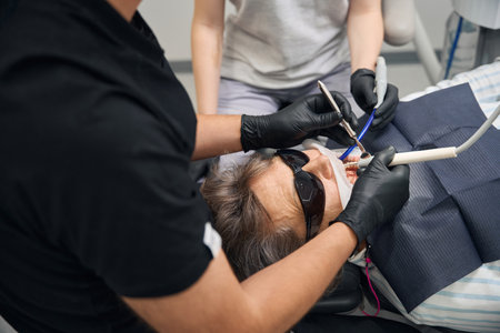 Lady is getting her teeth treated at a dental clinicの写真素材