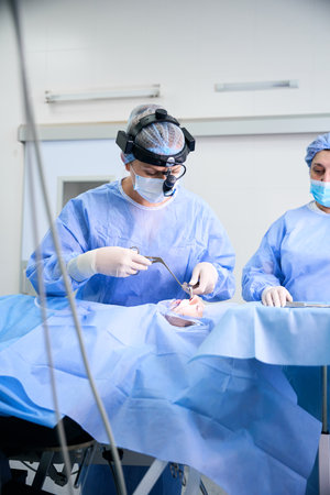 Surgeon performs an operation to straighten a deviated nasal septumの写真素材