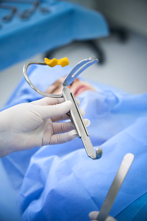 Operating nurse holds a special instrument in her hand
