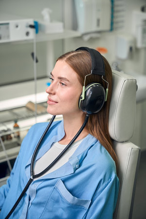 Patient with headphones during a medical examinationの写真素材