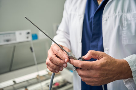 Close-up of doctor holding a medical instrumentの写真素材