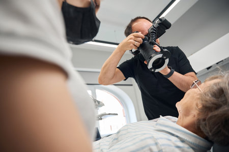 Dental prosthetist uses a special dental camera in his workの写真素材