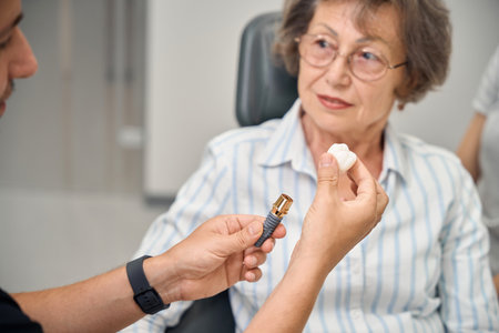 Dental prosthetist consults a pensioner at appointmentの写真素材