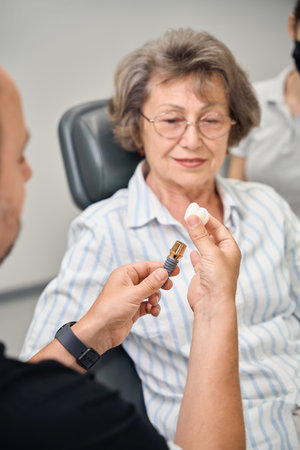 Dental prosthetist consults a patient at appointmentの写真素材