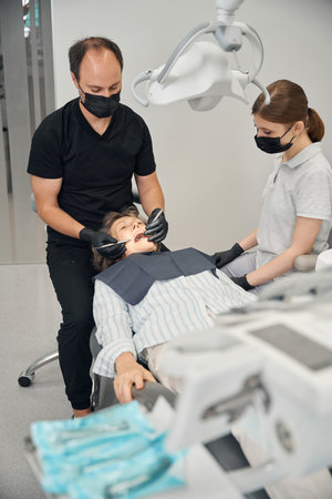 Lady lies in a modern dental chairの写真素材