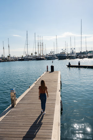 Traveling tourist woman on vacation walking at the port, Valencia, Spain