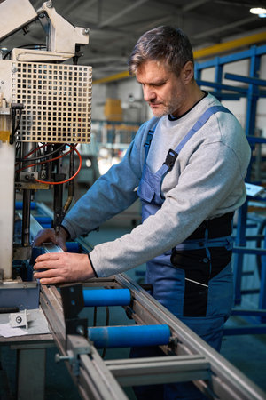 Proficient worker engaged in construction of PVC doors and windows