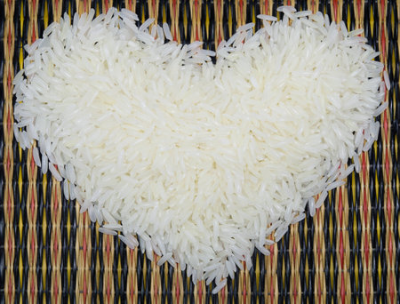 Heart shape rice on bamboo work backgroundの写真素材