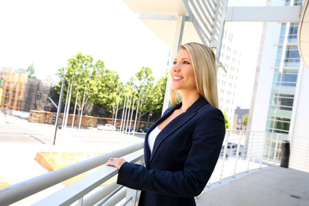 young simle businesswoman standing in the office buildingsの写真素材