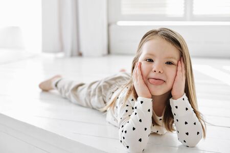 A little girl sitting on a table. High quality photoの写真素材