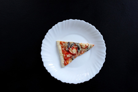 slace pizza with mushrooms on black background