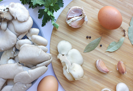 Edible still life with mushrooms, eggs, garlic, pepper, Bay leafの写真素材