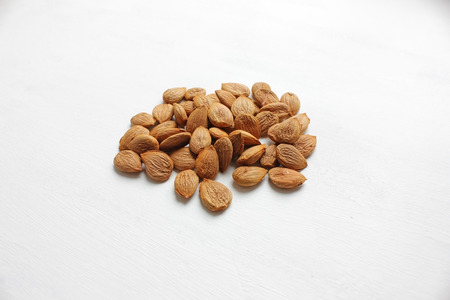bunch of apricot pits on a white backgroundの写真素材