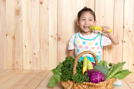 Little girl with basket of organic Vegetables.の写真素材