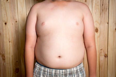 Fat boy, The size of stomach of children with overweight.の写真素材