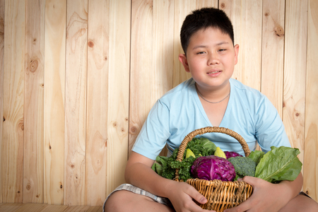 Young boy  with basket of organic Vegetables.の写真素材