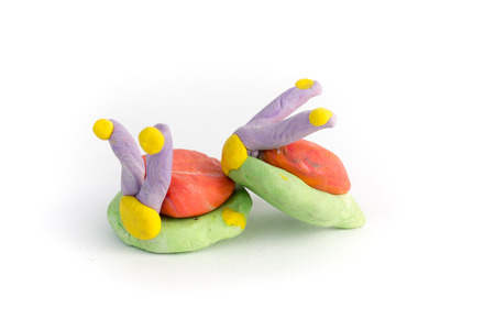 Kid's modelling snails clay model isolated on whiteの写真素材