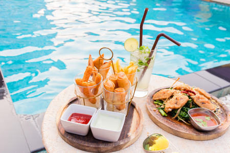 mix snack break with margarita cocktail near the swimming pool in relax time.の写真素材