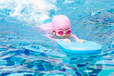 Soft focus Little girl swimming in pool.の写真素材
