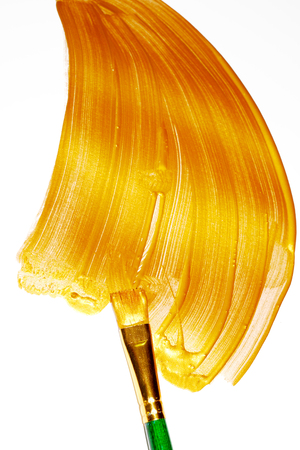 Gold paint brush stroke and brushの写真素材