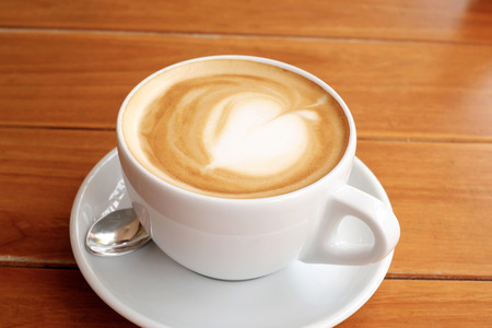Coffee in white cup on wood tableの写真素材