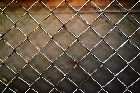 Old steel mesh grille backgroundの写真素材