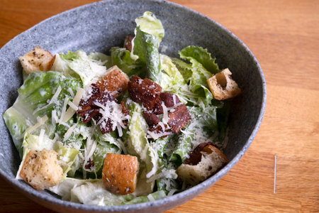 Caesar salad in a bowl on the tableの写真素材