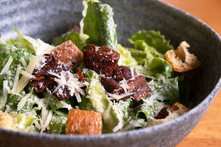 Caesar salad in a bowl on the tableの写真素材