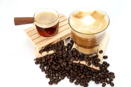 hot latte with coffee beans on white backgroundの写真素材