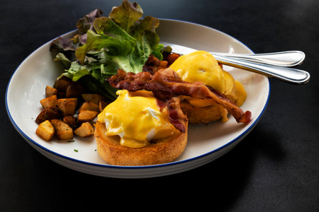 Eggs Benedict Bacon Breakfast on the Tableの写真素材