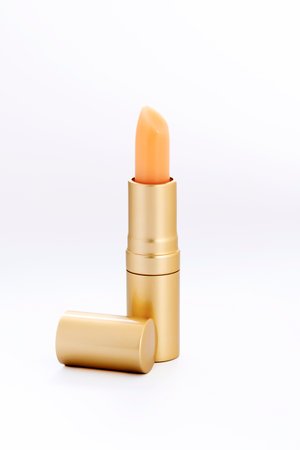lipstick in a golden tube on a white backgroundの写真素材