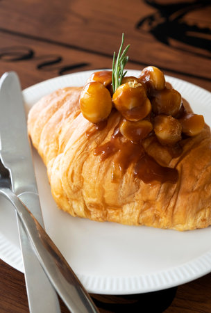 Macadamia croissants on a wooden tableの写真素材