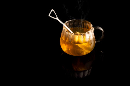 Hot tea on black background and reflectionの写真素材