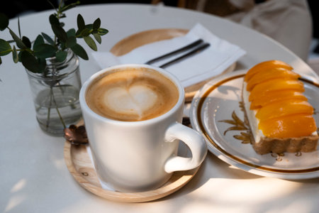 Afternoon hot coffee with mango cheesecakeの写真素材
