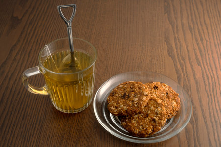 Hot tea and cookies on wooden tableの写真素材