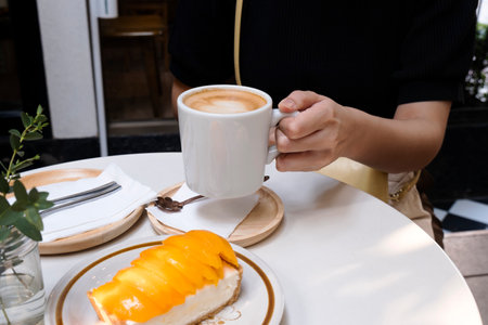 Afternoon hot coffee with mango cheesecakeの写真素材