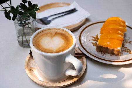 Afternoon hot coffee with mango cheesecakeの写真素材