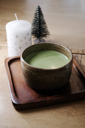 Hot matcha green tea on wooden tableの写真素材