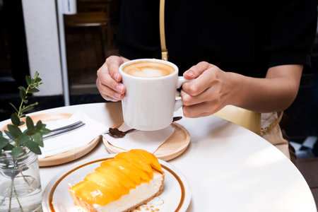 Afternoon hot coffee with mango cheesecakeの写真素材
