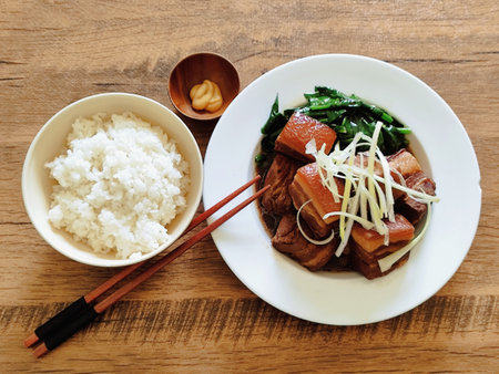 Japanese-style stewed pork belly on a wooden tableの写真素材