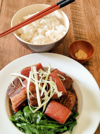 Japanese-style stewed pork belly on a wooden tableの写真素材