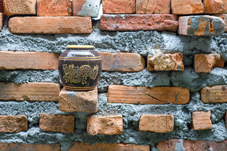 Water jar with small dragon pattern.Located on the mon brick. Next to the wall.の写真素材