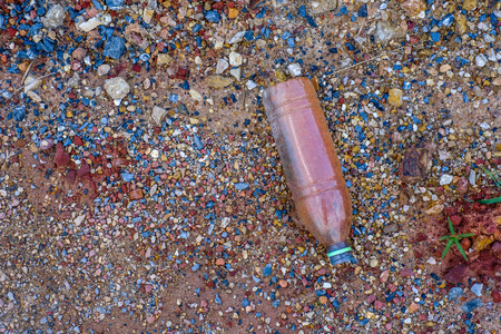 Waste plastic bottles are dumped on the ground.の写真素材