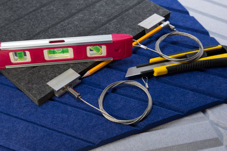 Polyester acoustic panels, knife, level, pencil and cable mounts for hanging from the ceiling