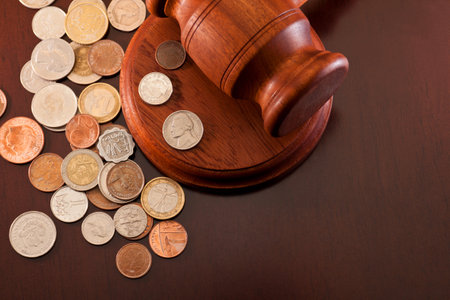 Coins from different countries and gavel